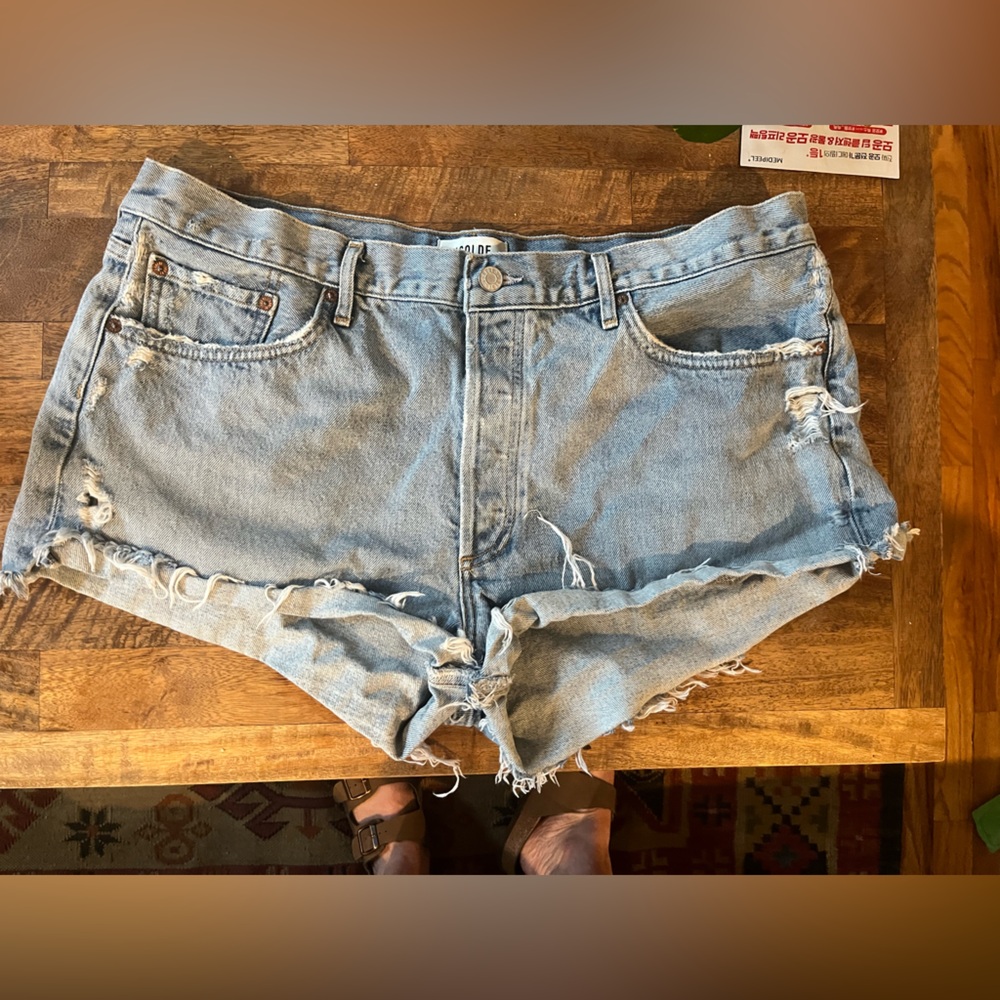 Agolde light wash denim cut off shorts, size 34